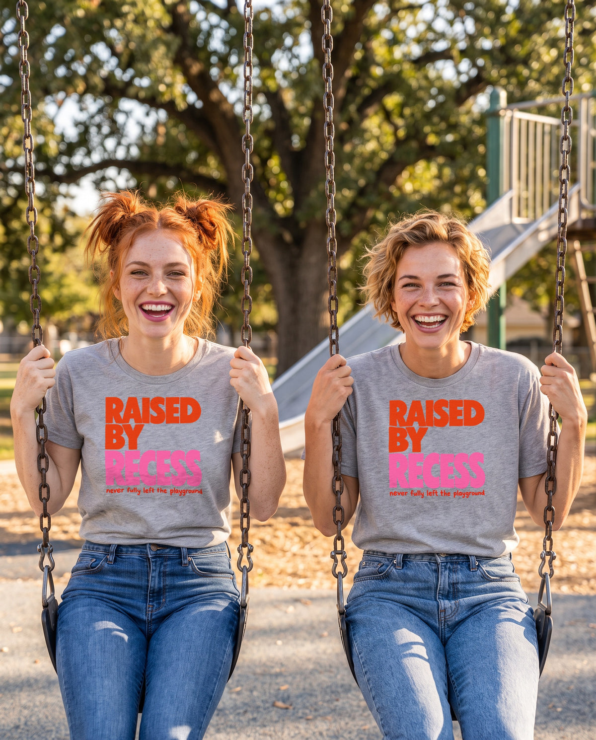 AI-generated image: two friends laughing on playground swings, both wearing the heather grey Raised by Recess tee