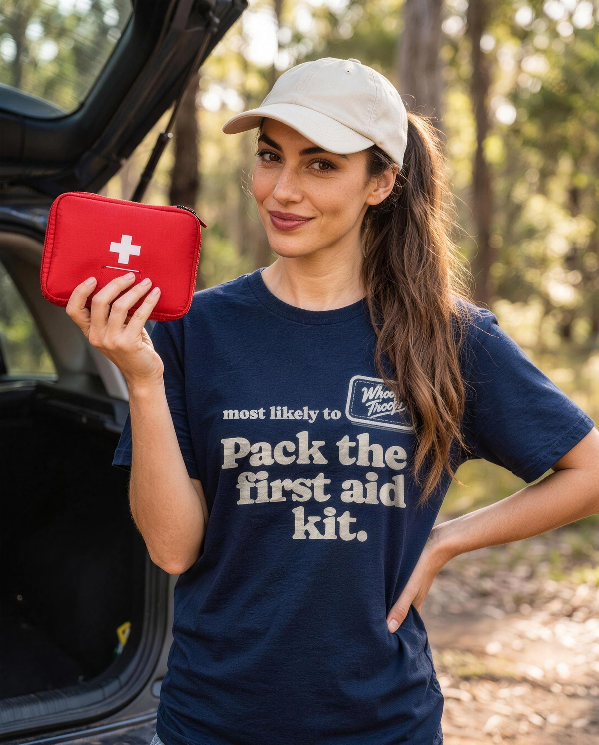 Most Likely To: Pack the First Aid Kit Tee (Dark), lifestyle photo (AI-generated model)