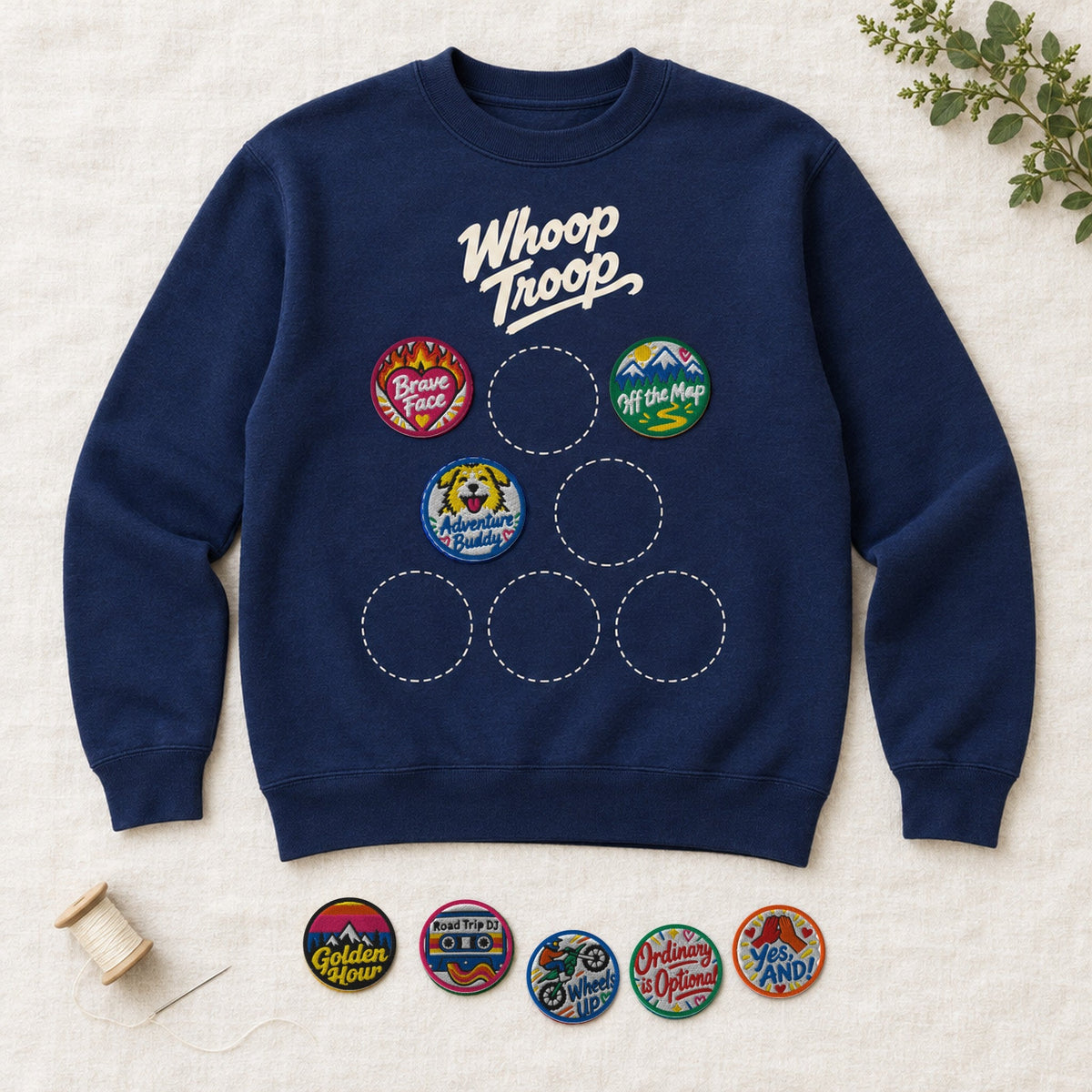 Navy Whoop Troop badge sweatshirt laid flat with starter badges sewn on and more beside it (AI-generated image)